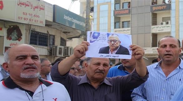 فلسطينيون يحملون صورة للكاتب الأردني ناهض حتر (المصدر)