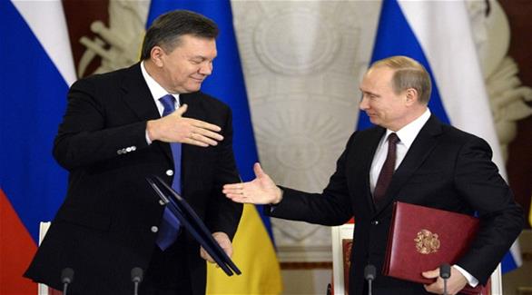 الرئيس الروسي فلاديمير بوتين والرئيس الأوكراني المعزول  فيكتور يانوكوفيتش (أرشيف)