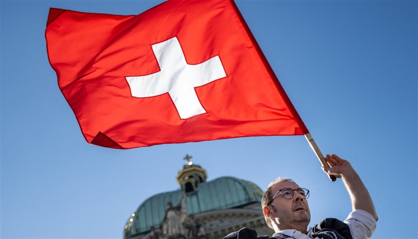 سويسري يرفع علم بلاده أمام البرلمان (أرشيف)